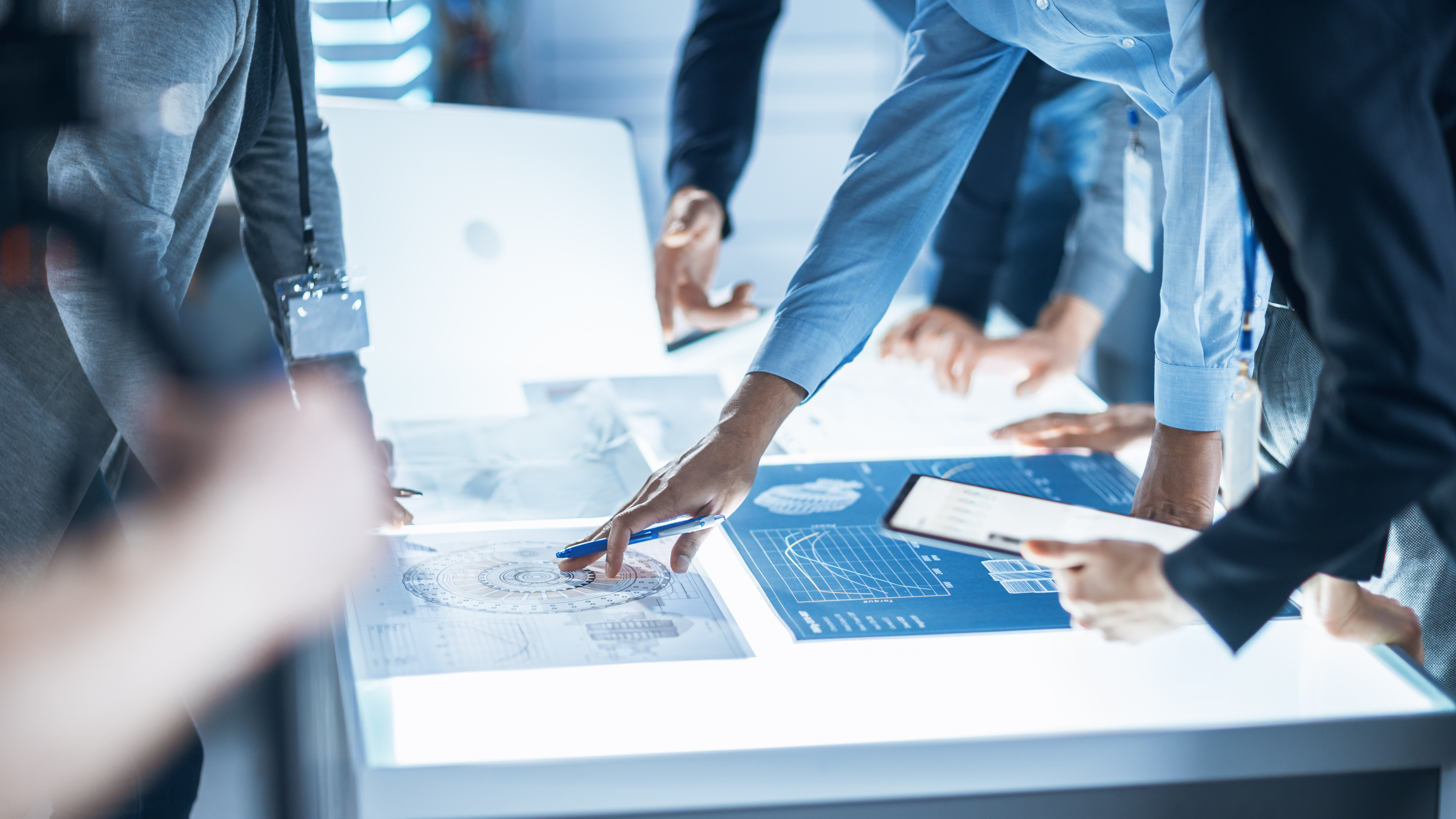 Group of people working on blue prints
