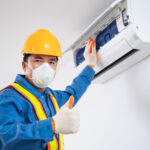 technician cleaning air conditioner indoors, Air conditioner technician