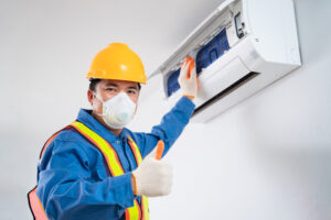 technician cleaning air conditioner indoors, Air conditioner technician